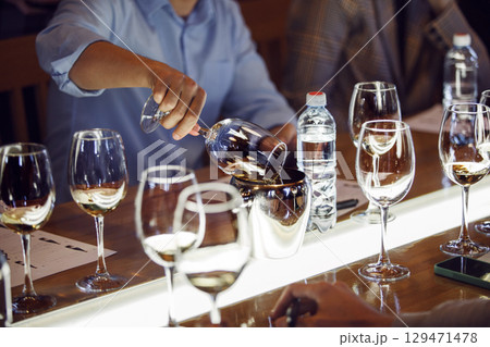 Close-Up View of Sommelier Pouring Wine Into Spittoon at Educational Wine School 129471478