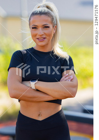 Active woman showcasing fitness outdoors with wearable technology and confident posture Active woman showcasing fitness outdoors with wearable technology and confident posture 129471576