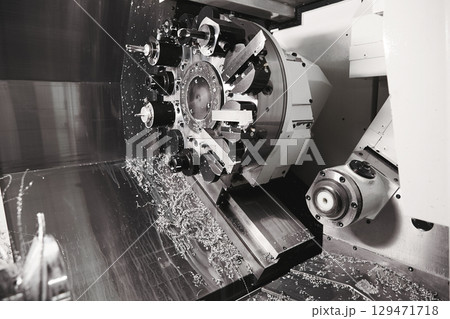 Tool Drum Revolving Lathe Fragment CNC Lathe Revolver Fixed Tools. Cutting groove of turning and milling machine on a metal shaft. High-tech manufacturing process of parts on a CNC lathe. 129471718