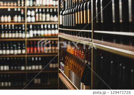 Well-Stocked Wine Cellar Shelves Lined With Diverse Bottles Well-Stocked Wine Cellar Shelves Lined With Diverse Bottles 129471728