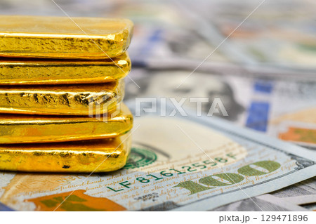 Paper us 100 dollar bill with gold bars, concept of investment and saving, wealth Paper us 100 dollar bill with gold bars, concept of investment and saving, wealth 129471896