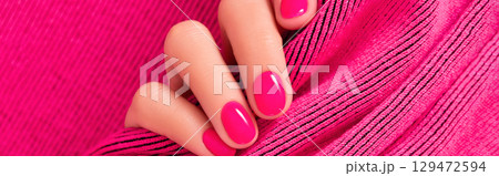 Close up beautiful womans hand with pink nail design. Manicure, pedicure beauty salon concept 129472594
