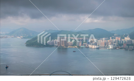 July 12 2025 Scenic City Skyline with Hills Surrounding Tranquil Waterfront Area 129472628