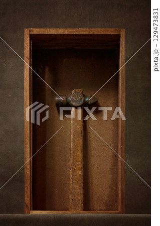 Still life with an old hammer in a wooden box Still life with an old hammer in a wooden box 129473831