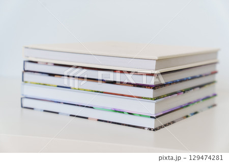Folded photo books with white leather and multi-colored photo covers. Folded photo books with white leather and multi-colored photo covers. 129474281