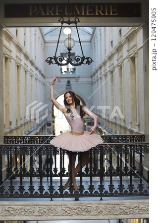 Ballerina in pink tutu posing on ornate balcony at Passage Pommeraye in Nantes Ballerina in pink tutu posing on ornate balcony at Passage Pommeraye in Nantes 129475905