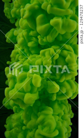 Green Ink Abstract Shape Under the Water. Isolated on Black Background. Vertical Aspect Ratio. 129478237