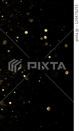 Abstract Golden Bokeh Glitter Background. Defocused Blur Spot Lights Isolated on Black Background. 129478253