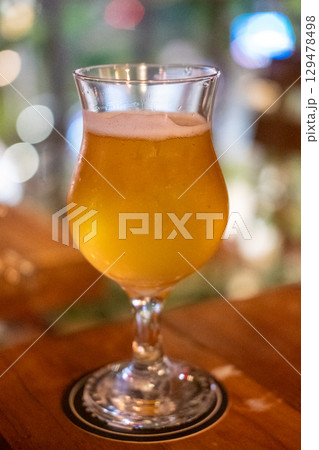 Glass of beer on the wooden table 129478498