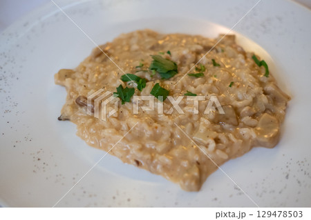 Risotto served on plate. It is a popular Italian rice dish. 129478503