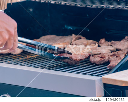 Grilling assorted meat on barbecue outdoors Grilling assorted meat on barbecue outdoors 129480483