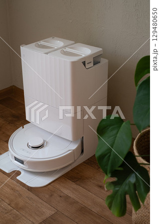 Robot vacuum works while owner rests providing clean and comfortable home with easy automatic cleaning every day 129480650