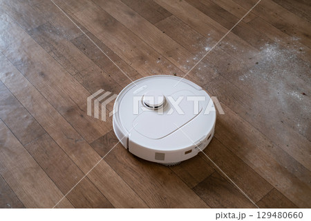 Robot assistant cleans the home efficiently giving the owner more free time for work relaxation or important daily tasks. Robot assistant cleans the home efficiently giving the owner more free time for work relaxation or important daily tasks. 129480660