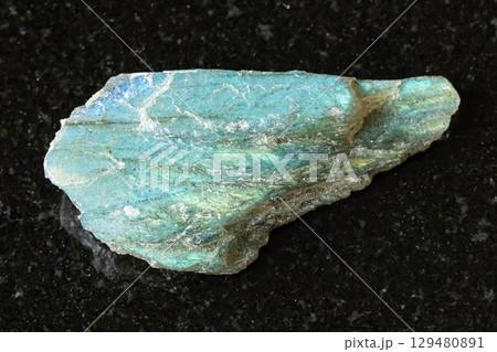 sample of raw green labradorite mineral on black sample of raw green labradorite mineral on black 129480891