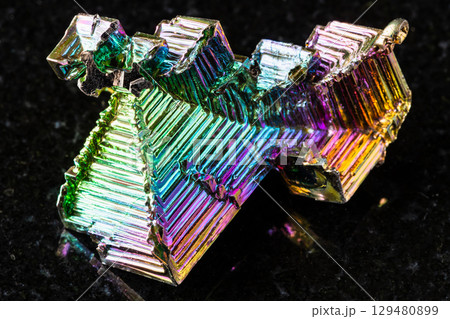 raw grown bismuth crystals mineral on black 129480899