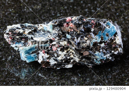 sample of raw kyanite in biotite rock on black 129480904