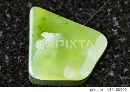 polished light green nephrite mineral on black polished light green nephrite mineral on black 129480906
