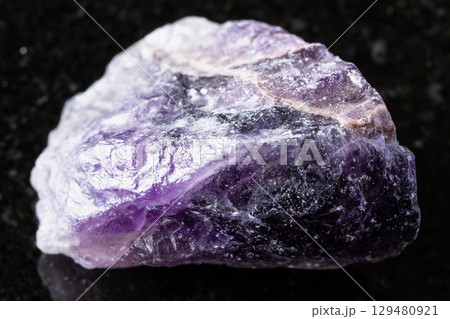 sample of unpolished amethyst mineral on black  129480921