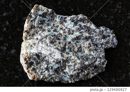 sample of raw gabbro-norite mineral on black 129480927