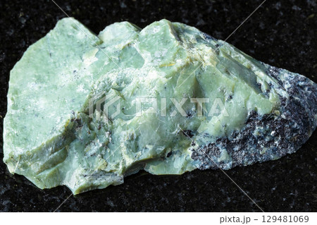 sample of raw teyskiy jade mineral on black 129481069