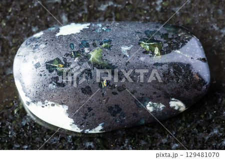 sample of polished teyskiy jade mineral on black 129481070