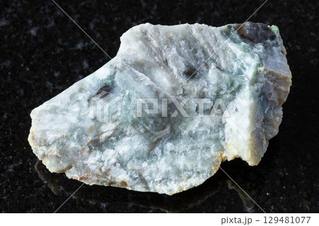 sample of raw trass chernomorite mineral on black 129481077