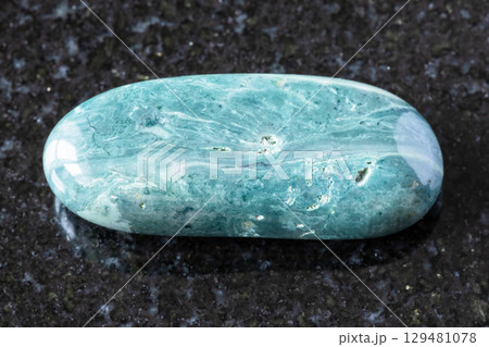 sample of tumbled chernomorite mineral on black sample of tumbled chernomorite mineral on black 129481078