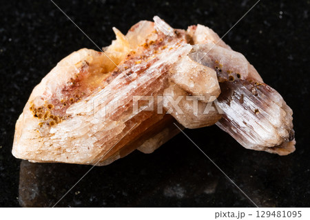sample of raw stilbite mineral on black granite sample of raw stilbite mineral on black granite 129481095