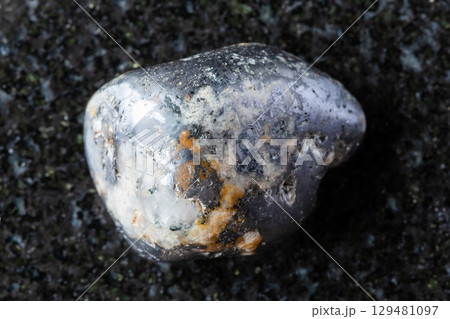 tumbled cleiophane and mushketovite rock on black 129481097