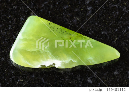sample of polished vesuvianite mineral on black 129481112