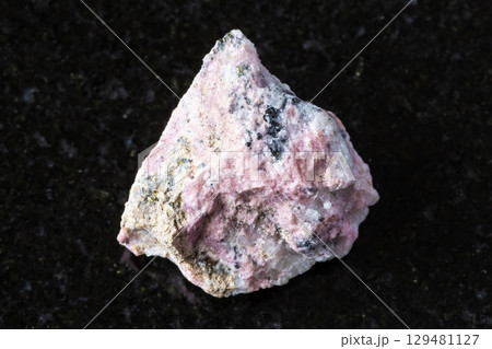 sample of raw pyroxmangite mineral on black 129481127