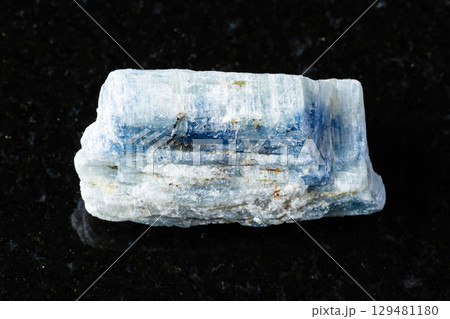 sample of rough kyanite rock on black granite sample of rough kyanite rock on black granite 129481180