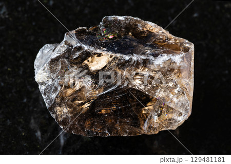 sample of raw smoky quartz mineral on black 129481181