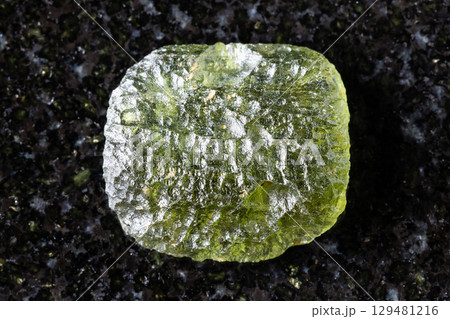 sample of raw moldavite tektite glass on black 129481216