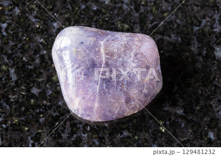 sample of tumbled cordierite mineral on black 129481232