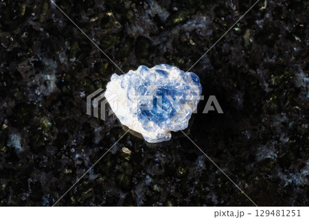 sample of raw blue spinel crystal on black granite sample of raw blue spinel crystal on black granite 129481251