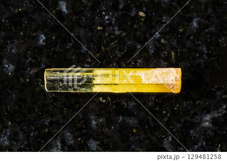 raw heliodor yellow beryl crystal on black raw heliodor yellow beryl crystal on black 129481258