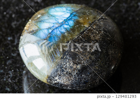 sample of polished labradorite stone on black 129481293