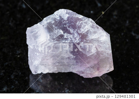 unpolished purple fluorite mineral on black unpolished purple fluorite mineral on black 129481301