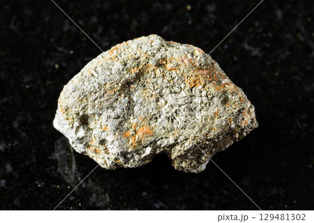 sample of uncut pyrite rock on black granite sample of uncut pyrite rock on black granite 129481302