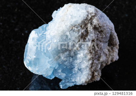 sample of raw celestite rock on black granite 129481316