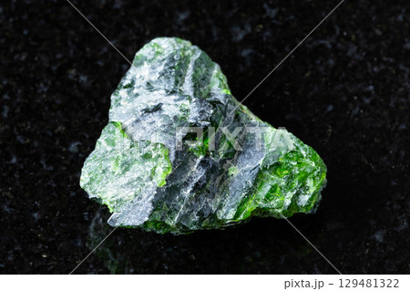 sample of rough chromian diopside rock on black 129481322