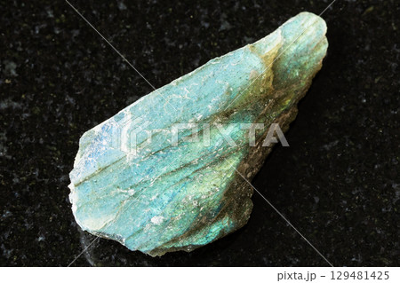 sample of rough green labradorite rock on black 129481425