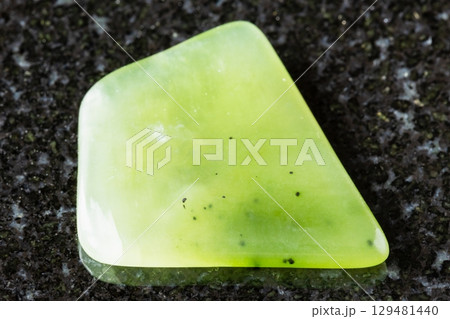 polished light green nephrite rock on black polished light green nephrite rock on black 129481440