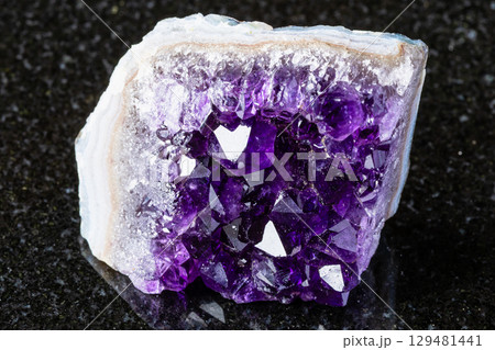 rough geode of amethyst mineral crystals on black rough geode of amethyst mineral crystals on black 129481441