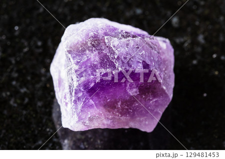 sample of raw amethyst mineral on black granite sample of raw amethyst mineral on black granite 129481453