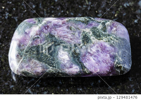 sample of tumbled kataranskite mineral on black 129481476