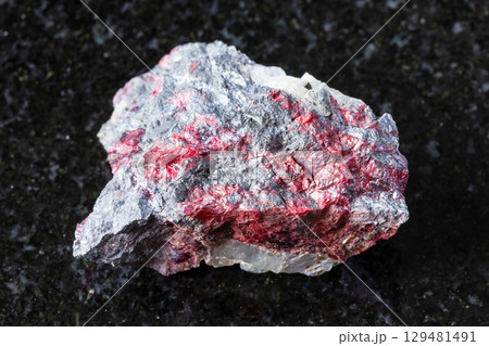raw cinnabar, stibnite on fluorite rock on black 129481491
