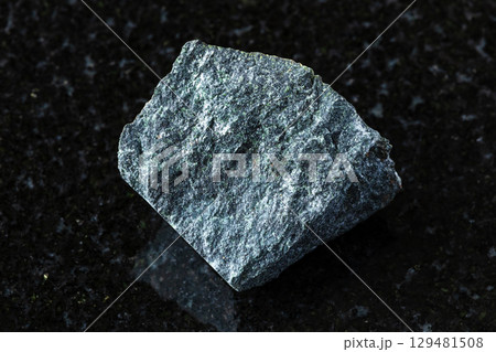 sample of peridotitic komatiite mineral on black 129481508