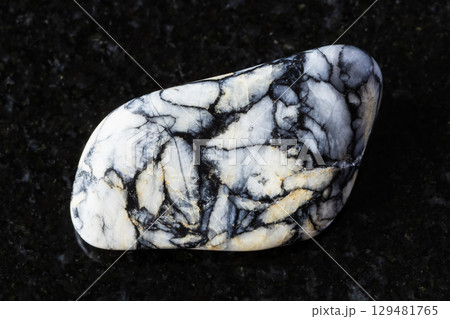 sample of tumbled pinolite mineral on black 129481765